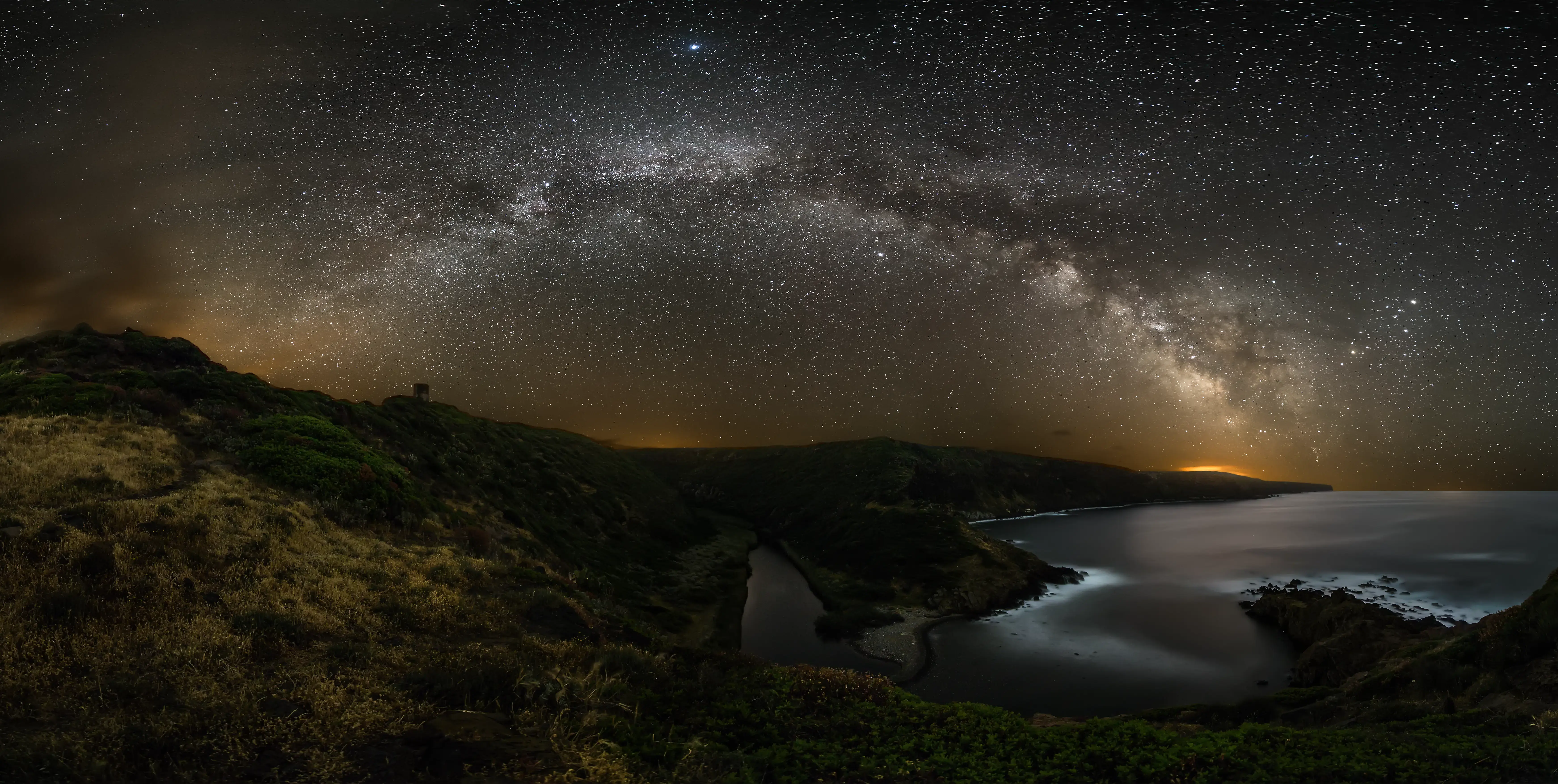 Starry sky over the wild coasts of Sardinia seen from a beach cabin